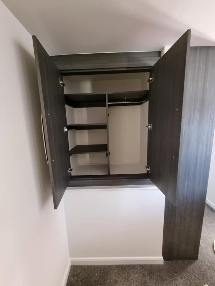 Alcove wardrobe open, showing bespoke shelving and hanging space, Edinburgh