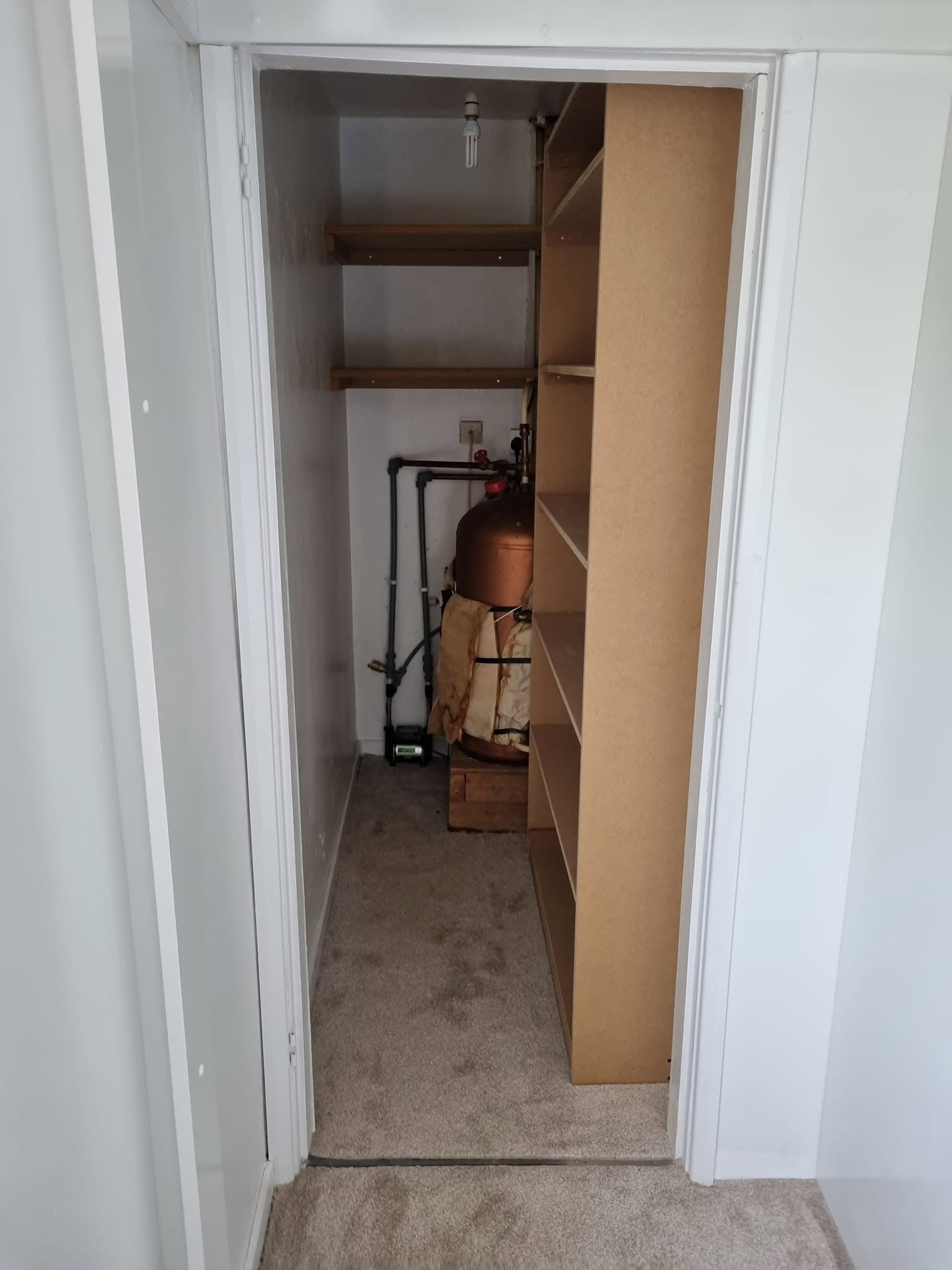 Walk-in wardrobe conversion in progress, with bespoke shelving built into an awkward storage space, Edinburgh